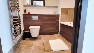 a bathroom with a toilet and a sink at Stylish Essex Apartment, Balcony & Scenic Views in Harlow