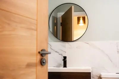 a bathroom with a mirror and a sink at 1 The Royal Serviced Apartments, Harwich SuperKing Bed, Parking, Fast WiFi in Parkeston