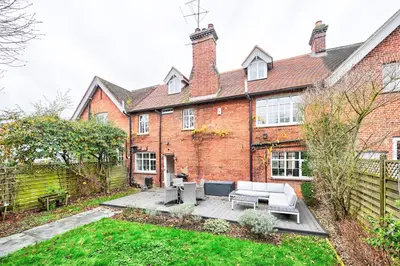 a brick house with a patio in front of it at Stylish 3-Bed Home Close to Stansted Airport in Stansted Mountfitchet