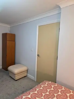 a bedroom with a bed and a closet and a door at Essex desk chair Free parking WiFi x3 in Hythe