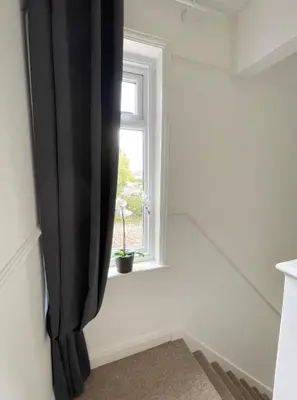 a room with a window with a potted plant at Spacious 4-Bed Home Near Cambridge City Centre in Chesterton