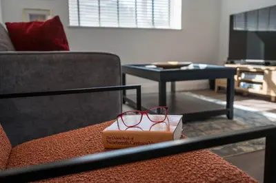 a pair of glasses sitting on a box on a couch at 1 Leiston Court, Leiston in Leiston