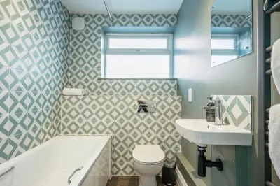 a bathroom with a white toilet and a sink at 1 Leiston Court, Leiston in Leiston