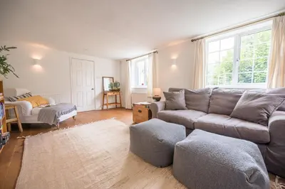 a living room with a couch and a chair at The Bantams, Monk Soham in Bedfield