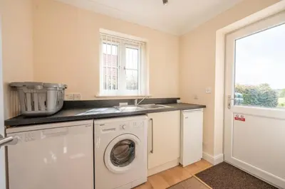a kitchen with a washing machine and a sink at Cosy 4BR Cottage in Great Glemham Village in Great Glemham