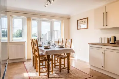 a kitchen with a table and chairs in a room at Cosy 4BR Cottage in Great Glemham Village in Great Glemham
