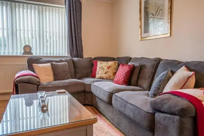 a living room with a couch and a coffee table at Cosy 4BR Cottage in Great Glemham Village in Great Glemham
