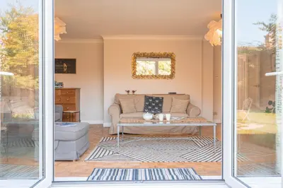 a living room with a couch and a table at 5 Church Close (7 guests), Aldeburgh in Aldeburgh