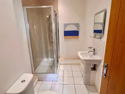 a bathroom with a shower and a toilet and a sink at Fabulous 2 bed in Leiston in Leiston