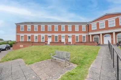 a bench in front of a large brick building at Fabulous 2 bed in Leiston in Leiston