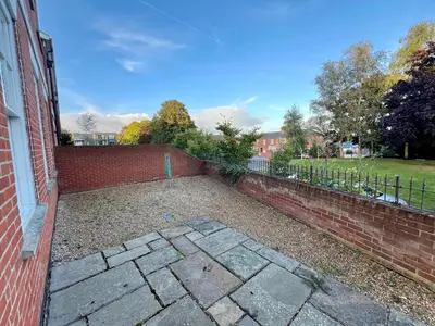 a brick retaining wall next to a brick building at Fabulous 2 bed in Leiston in Leiston