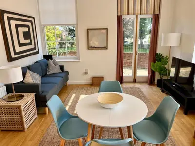 a living room with a couch and a table and chairs at Fabulous 2 bed in Leiston in Leiston
