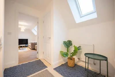 a living room with a green table and a window at Stylish 2BR in Wickham Market in Wickham Market