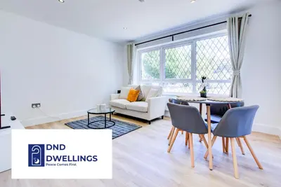 a living room with a table and chairs and a couch at Modern 4 Bed Home with Driveway in Colchester