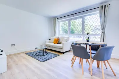 a living room with a table and a couch at Modern 4 Bed Home with Driveway in Colchester