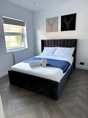 a bedroom with a large bed with a black headboard at Cosy Central Colchester Home by Castle Park in Colchester