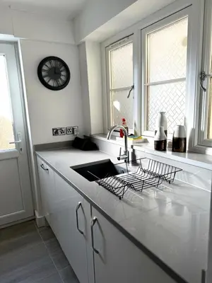 a white kitchen with a sink and a window at Cosy Central Colchester Home by Castle Park in Colchester