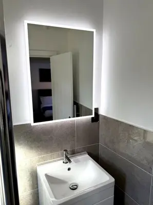 a bathroom with a white sink and a mirror at Cosy Central Colchester Home by Castle Park in Colchester