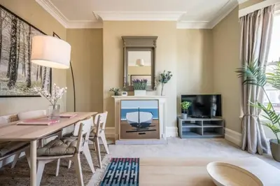 a living room with a dining table and a tv at Fabulous 1 bed in Aldeburgh in Aldeburgh
