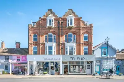 a large brick building with a store in front of it at Fabulous 1 bed in Aldeburgh in Aldeburgh