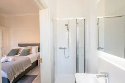 a bedroom with a bed and a glass shower at Fabulous 1 bed in Aldeburgh in Aldeburgh