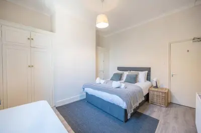 a bedroom with a large bed with a blue foot board at Fabulous 1 bed in Aldeburgh in Aldeburgh