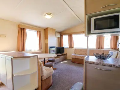 a small kitchen and living room in a caravan at Singh Leite & Luisa Family Caravan in Clacton-on-Sea