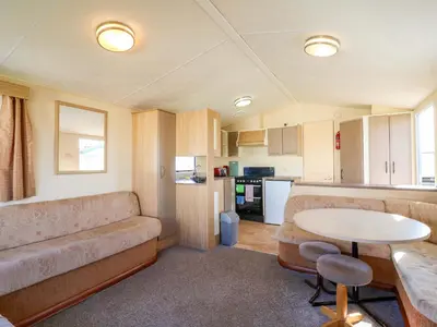 a living room with a couch and a table at Singh Leite & Luisa Family Caravan in Clacton-on-Sea