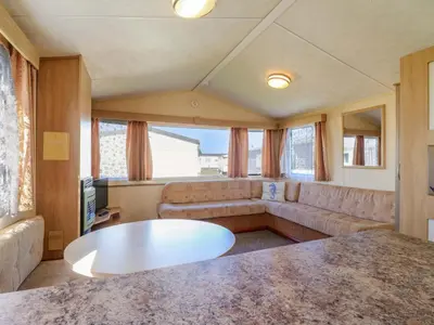 a living room with a couch and a table at Singh Leite & Luisa Family Caravan in Clacton-on-Sea
