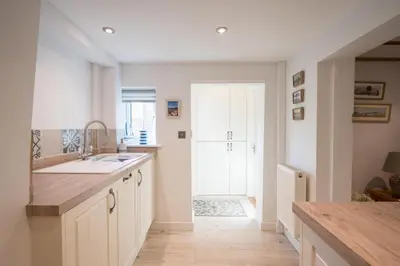 a kitchen with a sink and a counter top at 2 Beach Cottages, Thorpeness in Thorpeness