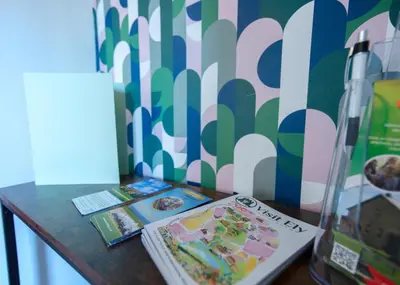a table with a book and some books on it at Bright & Airy 4x Bed House with Parking in Ely