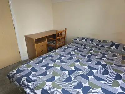 a bedroom with a bed and a wooden dresser at Free Parking WiFi Fresh linens x4 in Hythe