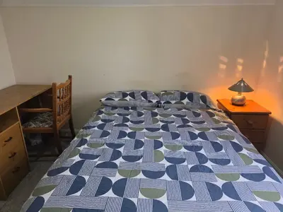 a bedroom with a bed with a blue and white comforter at Free Parking WiFi Fresh linens x4 in Hythe