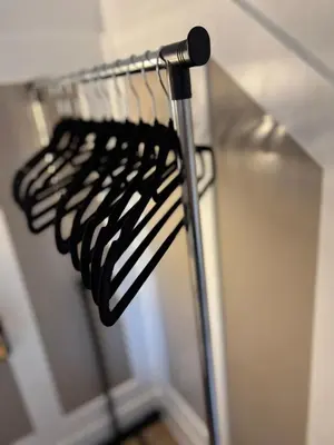 a row of black utensils on a rack at Stylish Garden pod lodges in Milton