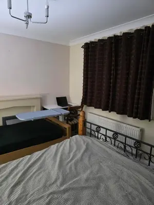a bedroom with a bed and a desk and a window at Cosy in Colchester x5 in Hythe