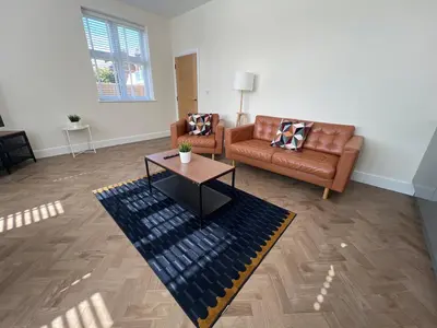 a living room with two couches and a coffee table at 4 The Royal Serviced Apartments, Harwich - Garden- Parking-Fast WiFi in Parkeston