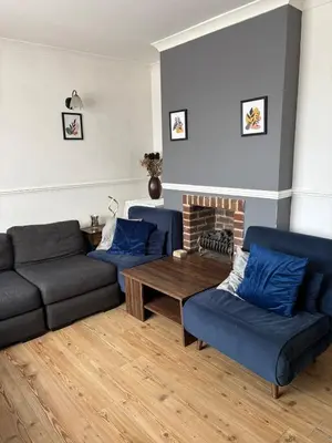 a living room with two couches and a coffee table at 3-bedroom family home with large garden and free parking in Loughton