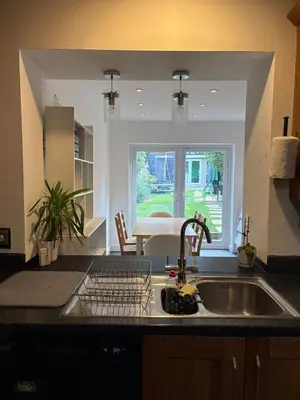 a kitchen counter with a sink and a window at 3-bedroom family home with large garden and free parking in Loughton
