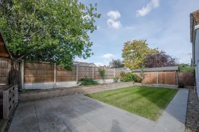 a backyard with a fence and a grass yard at Modern Comfort 4BR House in Colchester