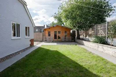 a backyard of a house with a grass yard at Modern Comfort 4BR House in Colchester