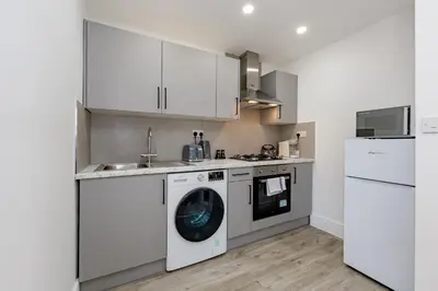 a kitchen with a washing machine and a dishwasher at Cosy and Peaceful flat in Benfleet close to station in South Benfleet