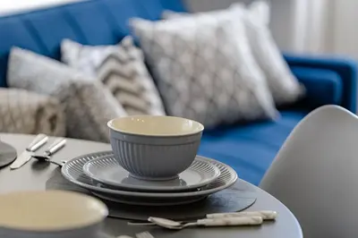 a table with a cup and plates on it at Cosy and Peaceful flat in Benfleet close to station in South Benfleet