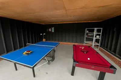 a room with two ping pong tables in it at Countryside Retreat - Indoor Pool, Sauna, Hot Tub in Fowlmere