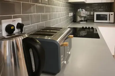 a kitchen with a toaster on a counter at Countryside Retreat - Indoor Pool, Sauna, Hot Tub in Fowlmere