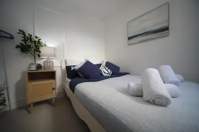 a bedroom with a bed with blue and white pillows at Modern 2Bedroom Apartment Free Private Parking Woodbridge Central in Woodbridge