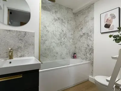 a bathroom with a white tub and a sink at Modern 2Bedroom Apartment Free Private Parking Woodbridge Central in Woodbridge