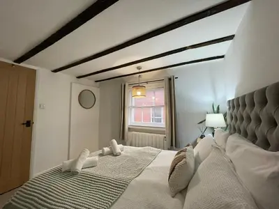 a bedroom with a large bed and a window at Modern 2Bedroom Apartment Free Private Parking Woodbridge Central in Woodbridge