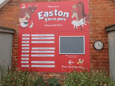a sign for a farm park on a brick wall at Molly Cow Shed 6 in Woodbridge