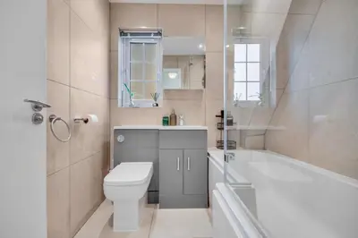 a bathroom with a toilet and a tub and a sink at Lovely 2-Bed House with parking in Broomfield