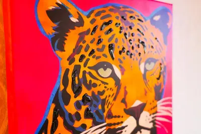 a painting of a jaguar on a wall at Bright & Spacious 5-Bedroom Stay near Cambridge in Hardwick